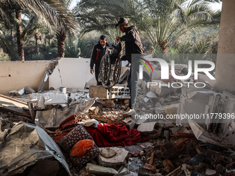 Palestinians inspect the site of an Israeli strike on a house in Deir Al-Balah in the central Gaza Strip on November 15, 2024. (