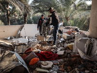 Palestinians inspect the site of an Israeli strike on a house in Deir Al-Balah in the central Gaza Strip on November 15, 2024. (