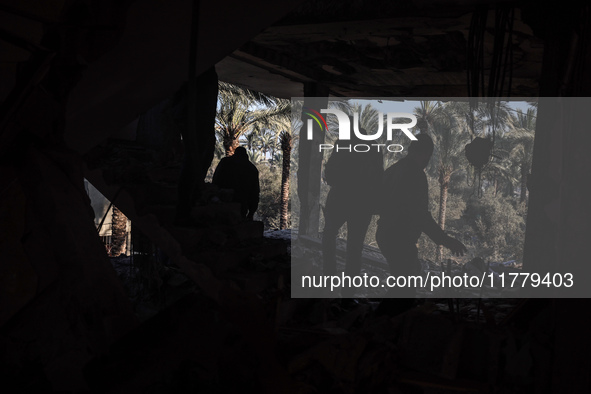 Palestinians inspect the site of an Israeli strike on a house in Deir Al-Balah in the central Gaza Strip on November 15, 2024. 