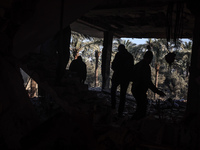 Palestinians inspect the site of an Israeli strike on a house in Deir Al-Balah in the central Gaza Strip on November 15, 2024. (