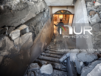 A Palestinian man inspects the site of an Israeli strike on a house in Deir Al-Balah in the central Gaza Strip on November 15, 2024. (