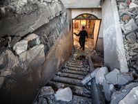 A Palestinian man inspects the site of an Israeli strike on a house in Deir Al-Balah in the central Gaza Strip on November 15, 2024. (