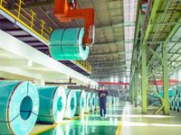 A worker produces precision stainless steel strip at the intelligent control center of Beitai Nantong Metal Technology Co., LTD in Haian, Ji...