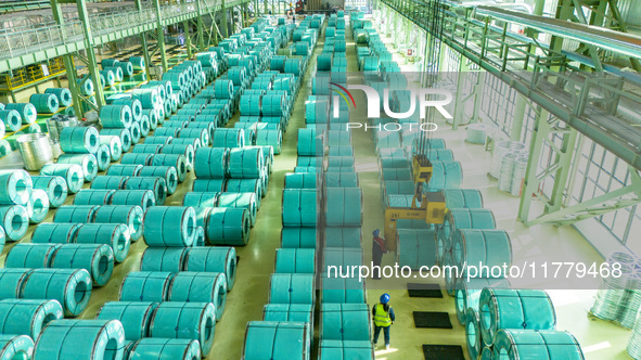 A worker produces precision stainless steel strip at the intelligent control center of Beitai Nantong Metal Technology Co., LTD in Haian, Ji...