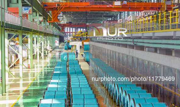 A worker produces precision stainless steel strip at the intelligent control center of Beitai Nantong Metal Technology Co., LTD in Haian, Ji...