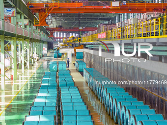 A worker produces precision stainless steel strip at the intelligent control center of Beitai Nantong Metal Technology Co., LTD in Haian, Ji...