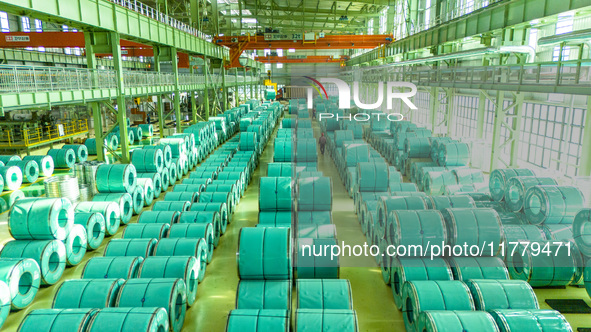 A worker produces precision stainless steel strip at the intelligent control center of Beitai Nantong Metal Technology Co., LTD in Haian, Ji...