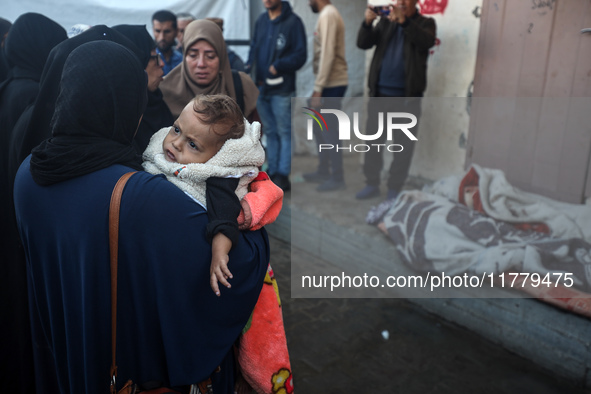 Relatives mourn during the funeral of Palestinians killed in an Israeli strike on tents of displaced people in Deir Al-Balah, Gaza Strip, on...