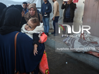 Relatives mourn during the funeral of Palestinians killed in an Israeli strike on tents of displaced people in Deir Al-Balah, Gaza Strip, on...