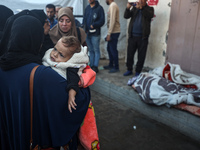 Relatives mourn during the funeral of Palestinians killed in an Israeli strike on tents of displaced people in Deir Al-Balah, Gaza Strip, on...