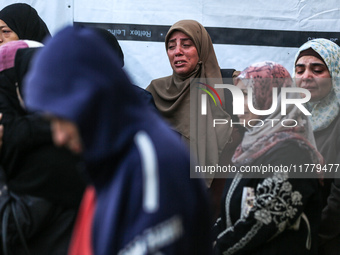 Relatives mourn during the funeral of Palestinians killed in an Israeli strike on tents of displaced people in Deir Al-Balah, Gaza Strip, on...