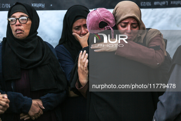 Relatives mourn during the funeral of Palestinians killed in an Israeli strike on tents of displaced people in Deir Al-Balah, Gaza Strip, on...