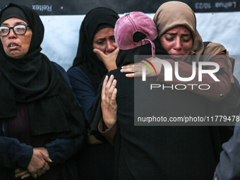 Relatives mourn during the funeral of Palestinians killed in an Israeli strike on tents of displaced people in Deir Al-Balah, Gaza Strip, on...