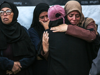 Relatives mourn during the funeral of Palestinians killed in an Israeli strike on tents of displaced people in Deir Al-Balah, Gaza Strip, on...