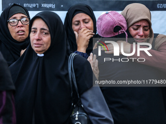 Relatives mourn during the funeral of Palestinians killed in an Israeli strike on tents of displaced people in Deir Al-Balah, Gaza Strip, on...