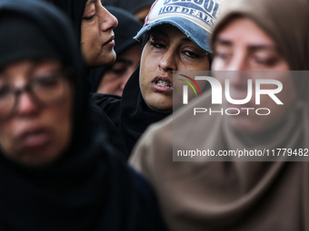 Relatives mourn during the funeral of Palestinians killed in an Israeli strike on tents of displaced people in Deir Al-Balah, Gaza Strip, on...