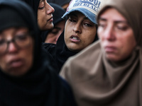 Relatives mourn during the funeral of Palestinians killed in an Israeli strike on tents of displaced people in Deir Al-Balah, Gaza Strip, on...