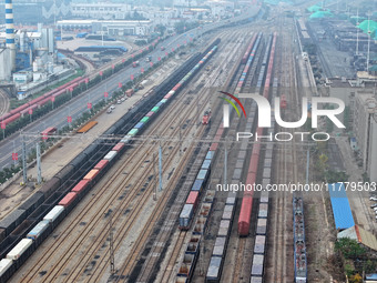 A China-Europe freight train loaded with containers waits to depart at the Lianyungang Port Railway marshalling station in Lianyungang, East...