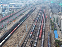 A China-Europe freight train loaded with containers waits to depart at the Lianyungang Port Railway marshalling station in Lianyungang, East...