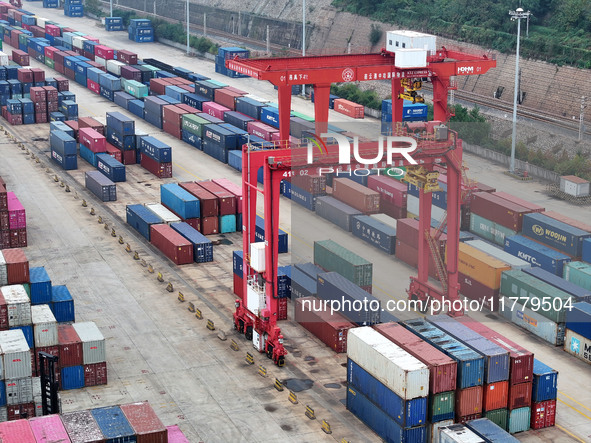 Large machinery loads containers onto the China-Kazakhstan (Lianyungang) Logistics Cooperation Base for the China-Europe freight train in Li...