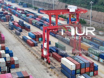 Large machinery loads containers onto the China-Kazakhstan (Lianyungang) Logistics Cooperation Base for the China-Europe freight train in Li...