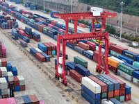 Large machinery loads containers onto the China-Kazakhstan (Lianyungang) Logistics Cooperation Base for the China-Europe freight train in Li...