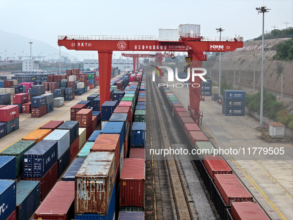 Large machinery loads containers onto the China-Kazakhstan (Lianyungang) Logistics Cooperation Base for the China-Europe freight train in Li...