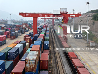 Large machinery loads containers onto the China-Kazakhstan (Lianyungang) Logistics Cooperation Base for the China-Europe freight train in Li...