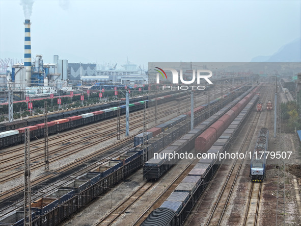 A China-Europe freight train loaded with containers waits to depart at the Lianyungang Port Railway marshalling station in Lianyungang, East...