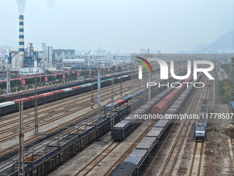 A China-Europe freight train loaded with containers waits to depart at the Lianyungang Port Railway marshalling station in Lianyungang, East...