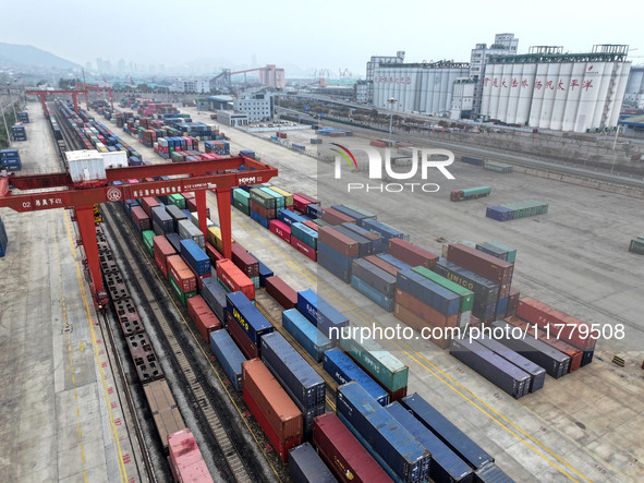 Large machinery loads containers onto the China-Kazakhstan (Lianyungang) Logistics Cooperation Base for the China-Europe freight train in Li...