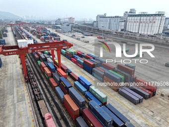 Large machinery loads containers onto the China-Kazakhstan (Lianyungang) Logistics Cooperation Base for the China-Europe freight train in Li...