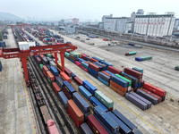 Large machinery loads containers onto the China-Kazakhstan (Lianyungang) Logistics Cooperation Base for the China-Europe freight train in Li...