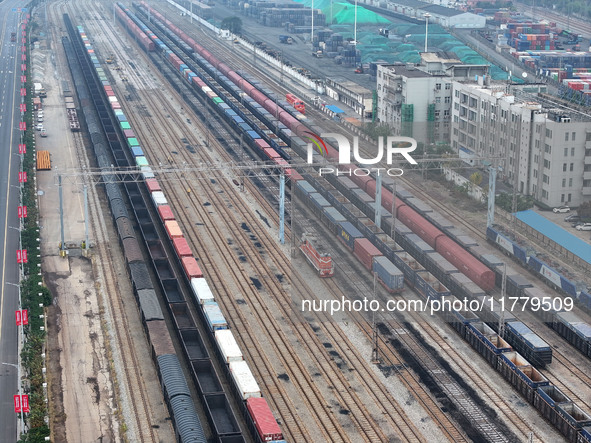 A China-Europe freight train loaded with containers waits to depart at the Lianyungang Port Railway marshalling station in Lianyungang, East...