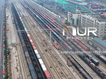 A China-Europe freight train loaded with containers waits to depart at the Lianyungang Port Railway marshalling station in Lianyungang, East...