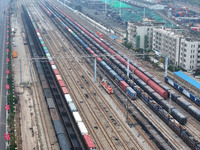 A China-Europe freight train loaded with containers waits to depart at the Lianyungang Port Railway marshalling station in Lianyungang, East...