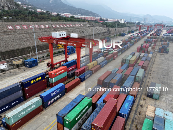 Large machinery loads containers onto the China-Kazakhstan (Lianyungang) Logistics Cooperation Base for the China-Europe freight train in Li...