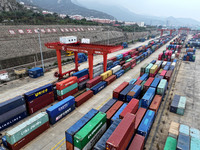 Large machinery loads containers onto the China-Kazakhstan (Lianyungang) Logistics Cooperation Base for the China-Europe freight train in Li...