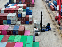 Large machinery loads containers onto the China-Kazakhstan (Lianyungang) Logistics Cooperation Base for the China-Europe freight train in Li...