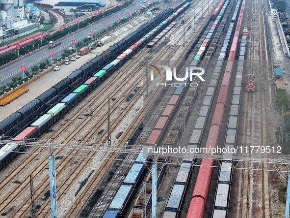 A China-Europe freight train loaded with containers waits to depart at the Lianyungang Port Railway marshalling station in Lianyungang, East...