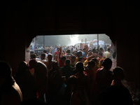 Hindu people gather to float small decorated boats made with banana stems as they take a holy dip in the river Ganges on the occasion of a h...