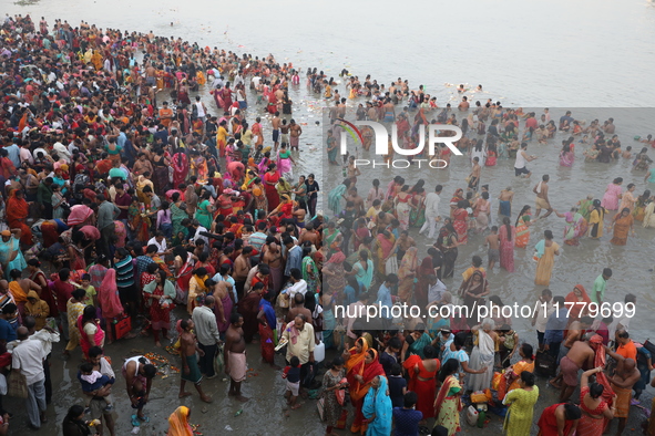 Hindu people gather to float small decorated boats made with banana stems as they take a holy dip in the river Ganges on the occasion of a h...