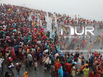 Hindu people gather to float small decorated boats made with banana stems as they take a holy dip in the river Ganges on the occasion of a h...