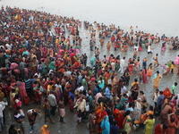 Hindu people gather to float small decorated boats made with banana stems as they take a holy dip in the river Ganges on the occasion of a h...