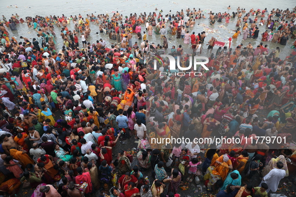 Hindu people gather to float small decorated boats made with banana stems as they take a holy dip in the river Ganges on the occasion of a h...