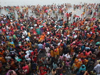 Hindu people gather to float small decorated boats made with banana stems as they take a holy dip in the river Ganges on the occasion of a h...