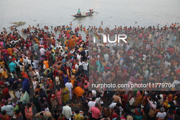 Hindu people gather to float small decorated boats made with banana stems as they take a holy dip in the river Ganges on the occasion of a h...