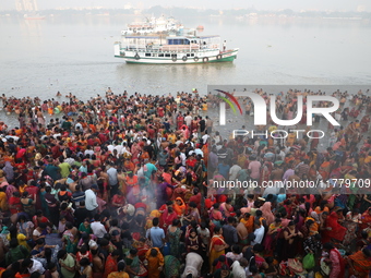 Hindu people gather to float small decorated boats made with banana stems as they take a holy dip in the river Ganges on the occasion of a h...