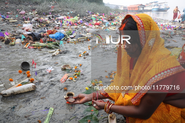 Hindu people offer prayers and float small decorated boats made with banana stems as people gather to take a holy dip in the river Ganges on...