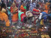 Hindu people offer prayers and float small decorated boats made with banana stems as people gather to take a holy dip in the river Ganges on...